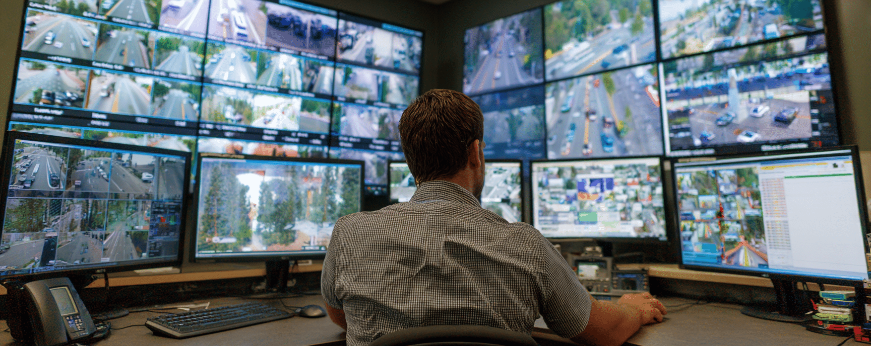 Policeman checking surveillance traffic camera footage